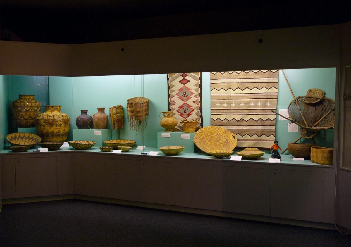P1010941.jpg - It's a very eclectic collection. Here is a display of old native baskets and pottery.