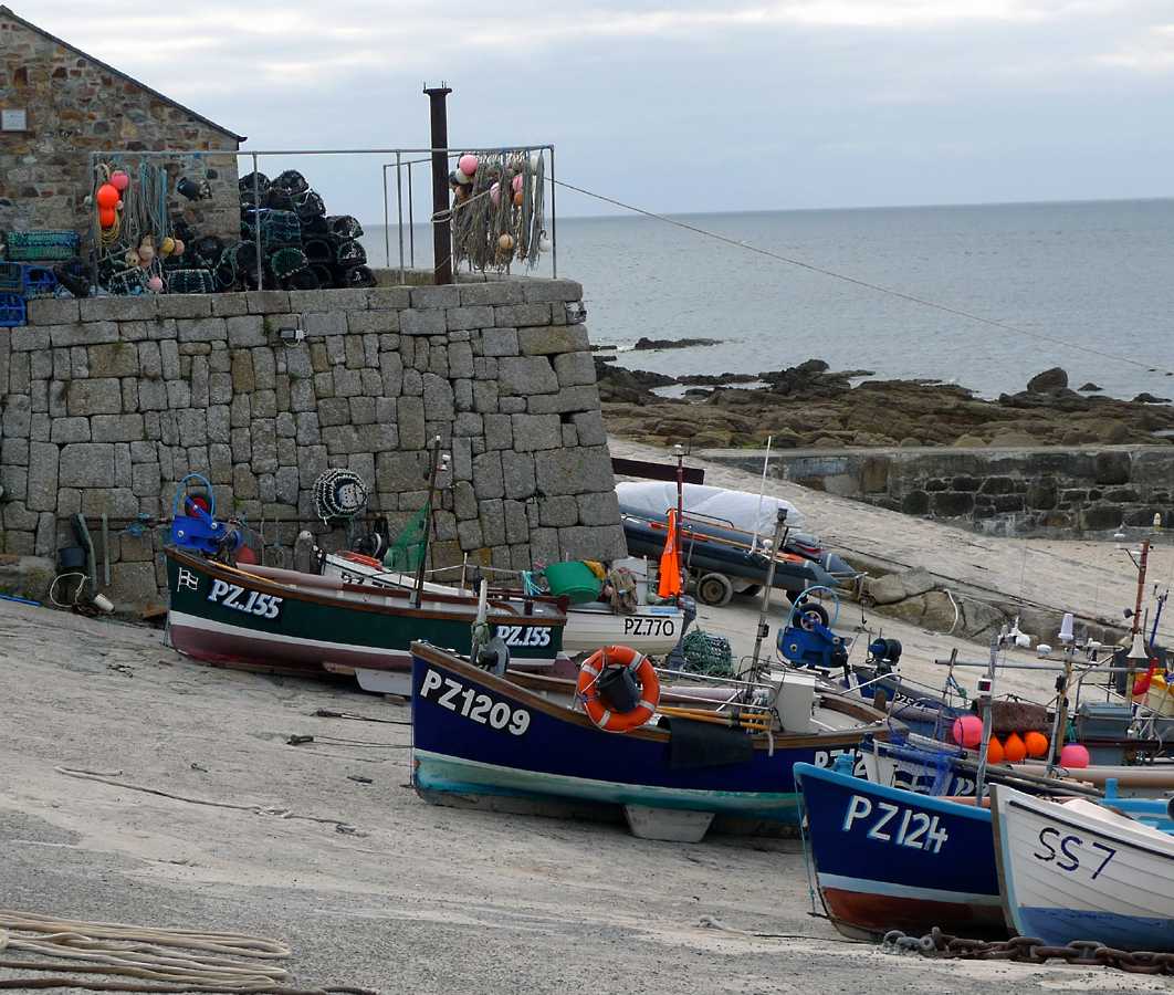 L1010353.JPG - The fishing fleet with the life boat station behind. Note the twin keels used to keep the boats upright while on the hard.